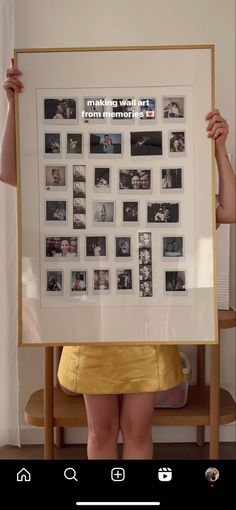 a woman holding up a framed photo with photos on it