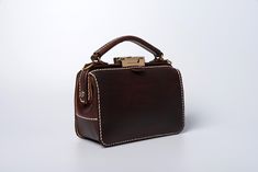 "*DOCTOR BAG'S HANDMADE VIDEO* https://youtu.be/QpdhSCjh2BM Product Description * Material: vegetable tanned leather * Color: Hand-dyeing chocolate * Flap over entry with buckle closure ,a rounded projection on the, please press it up to open the flap * 0.75\" wide leather shoulder strap : 110cm * Sewn by hand; * Size: 140mm (H) x 170mm (W) x 70mm (D) / 5.5\" x 6.7\" x 2.7\" Please first look at the production process of our product. 1. The vegetable tanned leather is made in Italy: Vegetable ta Leather Pouch Box Bag With Top Carry Handle, Classic Pouch Shoulder Bag, Brown Leather Box Bag With Handles, Vintage Leather Box Bag With Removable Pouch, Brown Leather Box Bag For Gift, Brown Leather Pouch Box Bag, Brown Leather Box Bag Gift, Brown Leather Satchel Box Bag, Brown Satchel Box Bag With Leather Handles