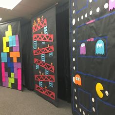 the walls in an office are decorated with different colored paper squares and video game characters