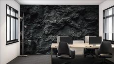 an office with black rock wallpaper and two computer desks