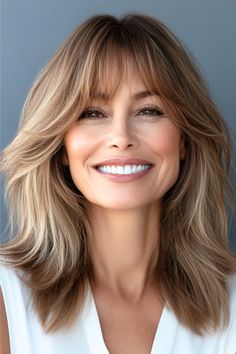 Feathered Mid-Length Layers with Bangs Hairstyle on a smiling woman in her 50s with brown hair. Medium Length Hair With Layers With Bangs Over 50, Medium Length Hair Styles With Bangs And Layers Over 40, Hairstyles For Medium Length Hair With Bangs Over 50 Women, Long Feathered Hairstyles With Bangs, Haircuts For Women Over 50 With Bangs, Mid Length Hairstyles For Women Over 50 With Bangs, Bangs Over 60, Feather Haircut