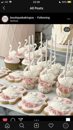 a table topped with lots of cupcakes covered in frosting