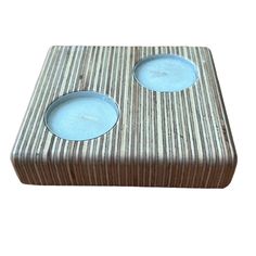 two tealight candles sitting on top of a wooden box with blue glass in the middle