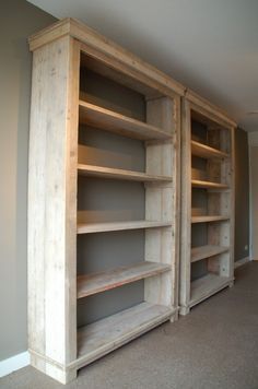 an empty room with two wooden shelves and carpeted flooring in front of the wall