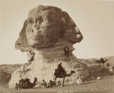 an old black and white photo of some people in front of a large sphinx