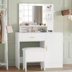 a white dressing table with mirror and stool