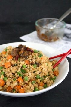 a white bowl filled with rice and vegetables