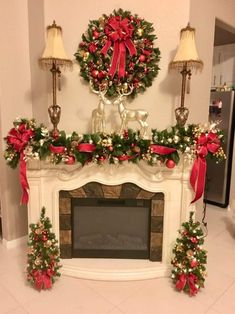 a fireplace decorated for christmas with wreaths and decorations