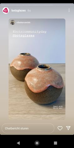 two brown vases sitting on top of a wooden table