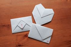 two envelopes are sitting on a wooden table