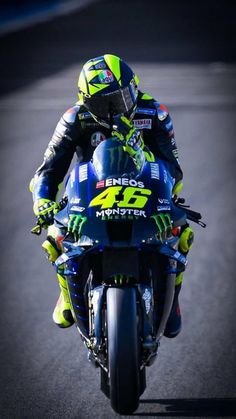 a man riding on the back of a blue motorcycle