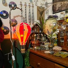 a table topped with lots of assorted items and lights on top of wooden dressers