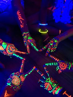 glow in the dark art project with neon colors and designs on wooden flooring,