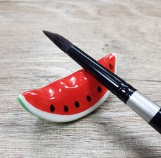 a pen sitting on top of a slice of watermelon