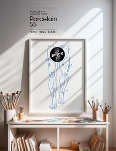 an art print is displayed in front of a white shelf with books and pencils on it