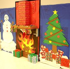 christmas decorations are displayed in front of a fireplace