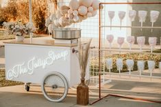 an ice cream cart is decorated with balloons