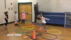 children are playing with different colored rings on the floor