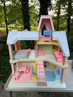 a toy doll house with furniture and accessories