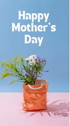 an orange bag with flowers in it and the words happy mother's day