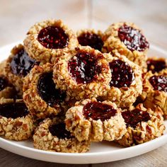 a white plate topped with cookies covered in jelly