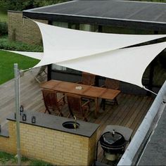 an aerial view of a patio with tables and chairs under a white awning over it