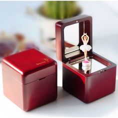 a small wooden box with a ballerina figure in it