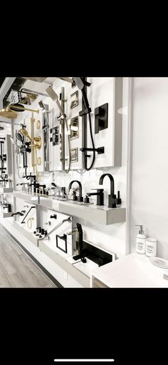 a white room with lots of black and gold items on the wall, including mirrors