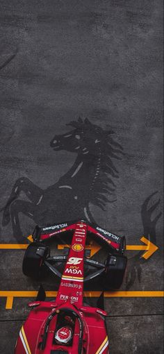 a ferrari racing car parked in front of a horse drawn shadow on the pavement,