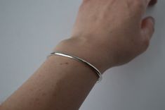 "Simple Hammered Sterling Silver Cuff! Each bracelet is handmade from solid sterling silver with a lightly hammered finish.  The ends of each are tapered giving them a more comfortable fit.   Sold as a single cuff or set of three. They are available in sizes 5 1/2\" - 8 1/2\" and are adjustable. PLEASE MEASURE your wrist with a flexible measuring tape in order to find the correct size.   We recommend ordering these bracelets in the same size or slightly larger than the length around your wrist, Sterling Silver Minimalist Bangle With Polished Finish, Minimalist Sterling Silver Chain Bracelet, Classic Handmade Sterling Silver Bracelet For Everyday, Dainty Sterling Silver Bangle, Simple Sterling Silver Bracelets For Everyday, Handmade Minimalist Cuff Bangle Bracelet, Minimalist Handmade Cuff Bangle Bracelet, Minimalist Polished Sterling Silver Bracelet, Everyday Sterling Silver Bangle Bracelet