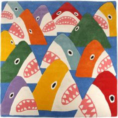 a rug with many different colored shark heads on the front and back of each one