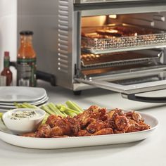 a plate full of food sitting in front of an oven