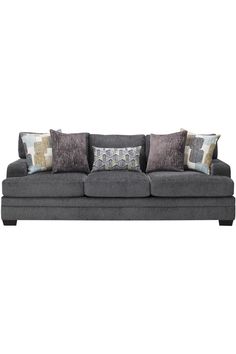 a gray couch with many pillows on it's back and sides, in front of a white background