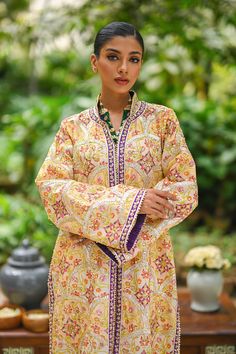 Tasnim; a quintessential amalgamation of our painterly prints, handcrafted details and signature silhouettes. The front open khaddi silk column jacket is edged with a playful purple border along its long length and sleeves. Paired with pure rawsilk trousers. Model height: 5'6 Length: 48 Silk Kurta With Digital Print And Long Sleeves, Silk Long Sleeve Kurta With Digital Print, Long Sleeve Raw Silk Kurta With Printed Motifs, Long Sleeve Silk Lawn Suit With Dabka, Silk Lawn Suit With Dabka And Long Sleeves, Silk Long Sleeve Outerwear For Eid, Festive Long Sleeve Silk Kimono, Painterly Prints, Purple Border