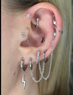 a woman with multiple piercings on her ear