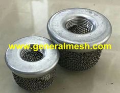 two metal mesh strainers sitting on top of a table