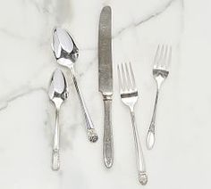 silverware on a marble counter top with utensils