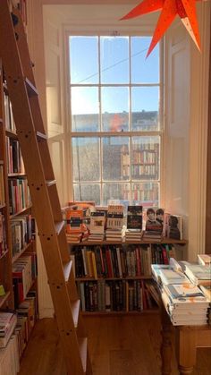 there is a ladder in front of the bookshelf with many books on it