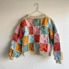 A multicolored granny square crochet sweater. Patchwork Crochet Projects, Patch Knit Sweater, Crochet Sweater Scrap Yarn, Easy Granny Square Sweater, Granny Square Crochet Sweater Pattern, Granny Square Sweater Layout, Crochet Patch Sweater