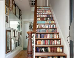 there is a stair case with many books on the shelves and below it are pictures