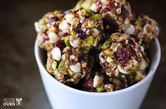 a white bowl filled with fruit and nuts