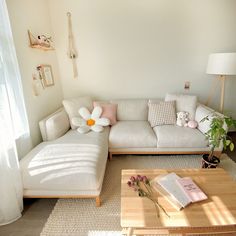 a living room with a white couch and coffee table