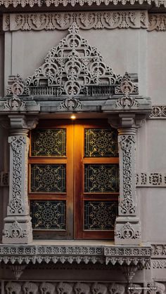 an old building with ornate iron work on the doors