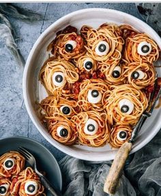 a bowl full of spaghetti with googly eyes on it