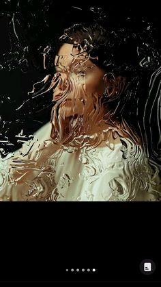 a woman's face is shown through the water droplets on her dress and hair