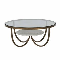 an oval glass table with metal legs and two white marble plates on the top,