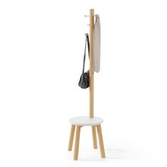 a coat rack with two coats hanging from it's sides and a purse on the back