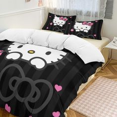 a black and white bed with hello kitty on it