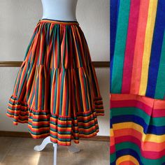 Gorgeous full circle rainbow skirt from the 70s! Pictured with a petticoat, not included -The only tag has a handwritten 30 on it -This feels like a cotton poly blend -Would fit a size small, 23" to 27" waist (maybe a tight 28") -Length: 29.5" Each side of the waist ties, so the waist is adjustable.  The ties can either be tied at the sides, or can be wrapped around each way and tied in the front and in the back.  There is no elastic and no other closures besides the ties.  The skirt is unlined. Very good vintage condition!  Clean and ready to wear. The only thing to note is light marking on part of the ties, but it's very faint and won't be seen when worn and ties are tied. This skirt is a wonderful piece and the colors are incredibly vibrant! All vintage items are unique and pre-loved, a Retro Full Skirt Petticoat With Ruffles, Spring Retro Petticoat, Vintage Long Skirt Petticoat, Retro Fitted Skirt For Festival, Retro Cotton Tiered Skirt, Vintage Tiered Skirt Bottoms For Festival, Retro Cotton Skirt, Vintage Multicolor Skirt, Multicolor Retro Festival Skirt