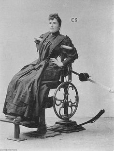 an old photo of a woman sitting in a wheel chair with a hose attached to it